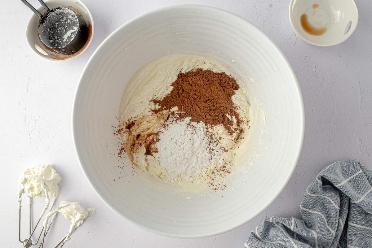 Cocoa powder and powdered sugar added to whipped cream.