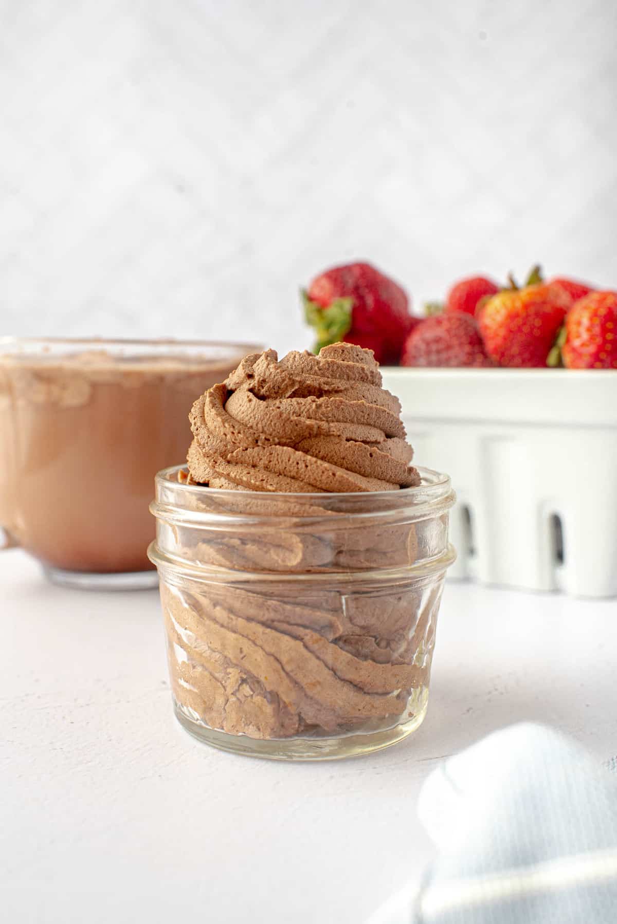 Chocolate whipped topping piped into a small glass jar.