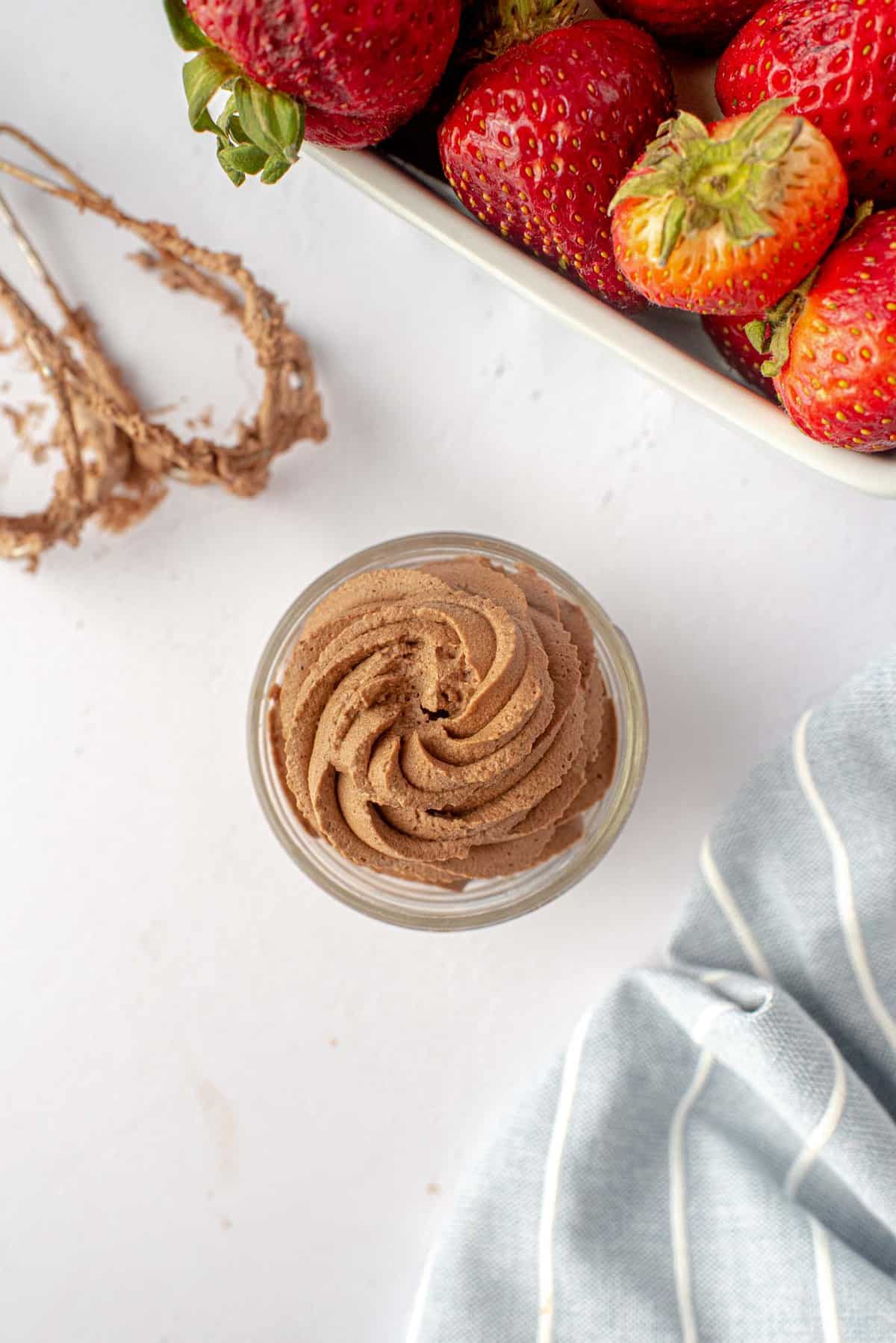 Chocolate whipped cream piped into a small jar.