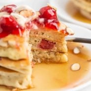 Cherry almond pancakes with a cut out to show texture.