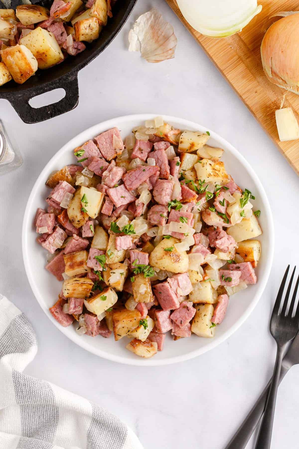 Corned beef and potatoes on a serving plate.
