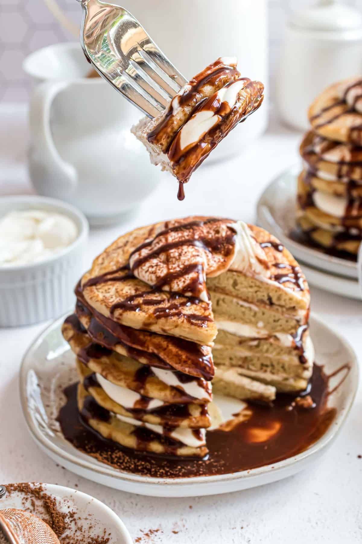 Pancakes on a fork, dripping with kahlua syrup.