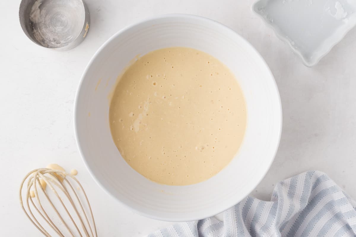 Pancake batter in a white mixing bowl.