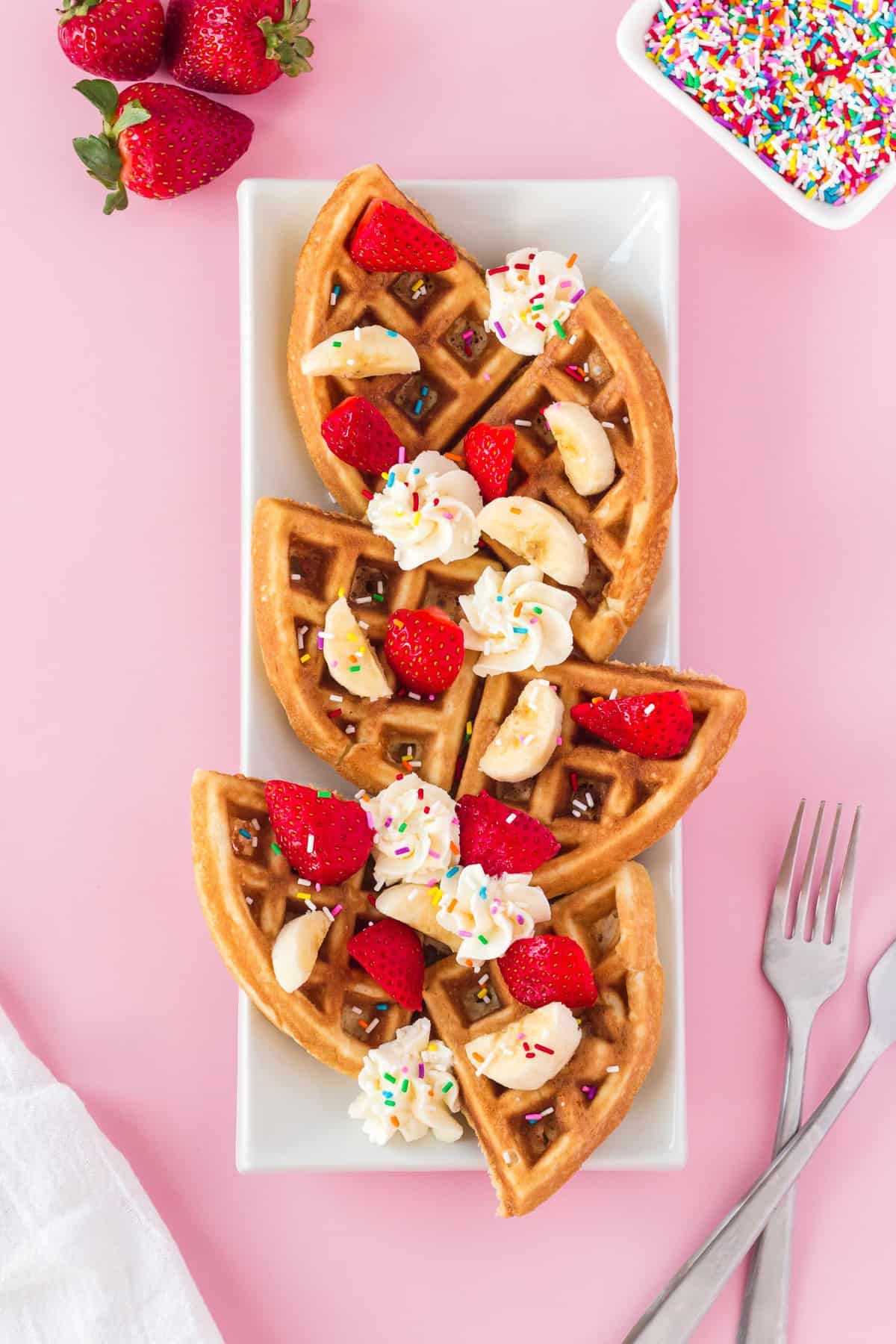 Waffles served in quarters in a rectangular platter.