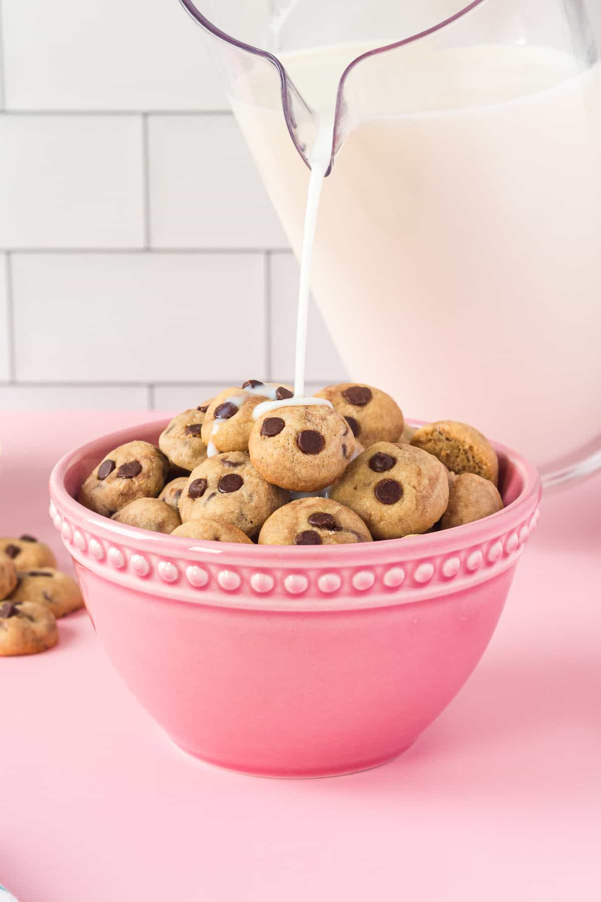 Milk being poured on chocolate chip cookie cereal.
