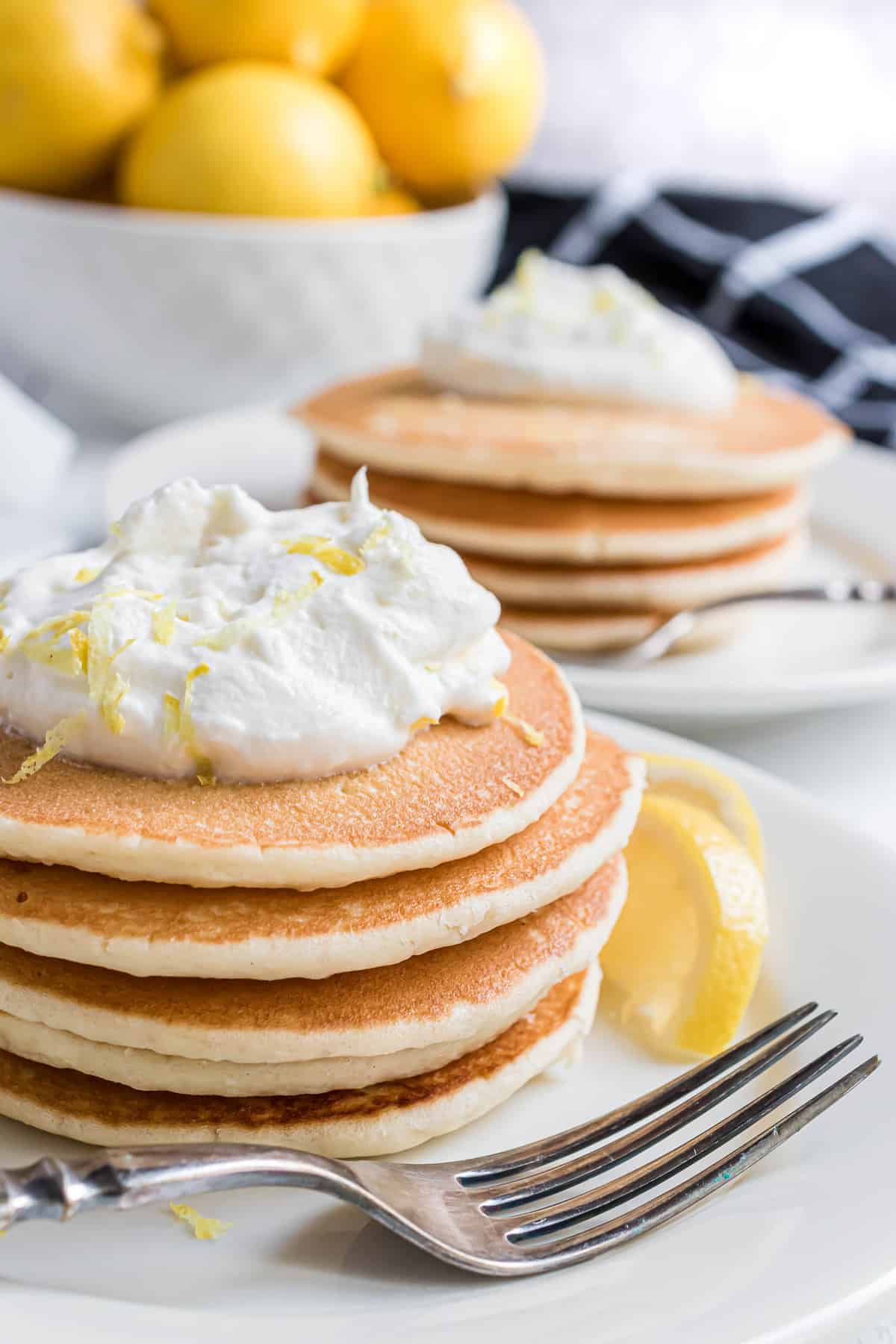 Lemon whipped cream on a stack of pancakes.