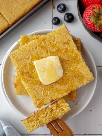 Cut square pancake topped with butter and syrup.