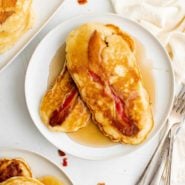 Bacon pancakes on a plate with syrup.