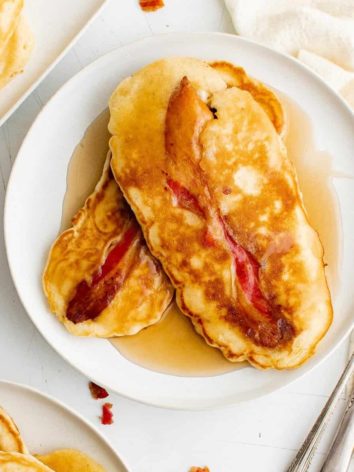 Bacon pancakes on a plate with syrup.