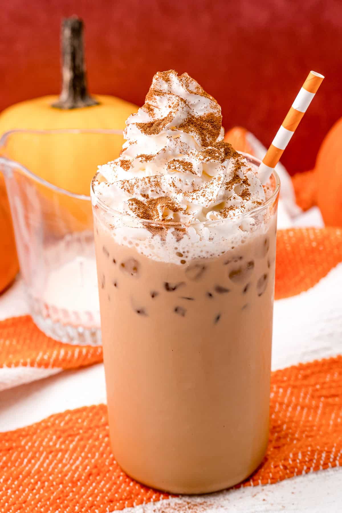 Iced latte on an orange and white background.