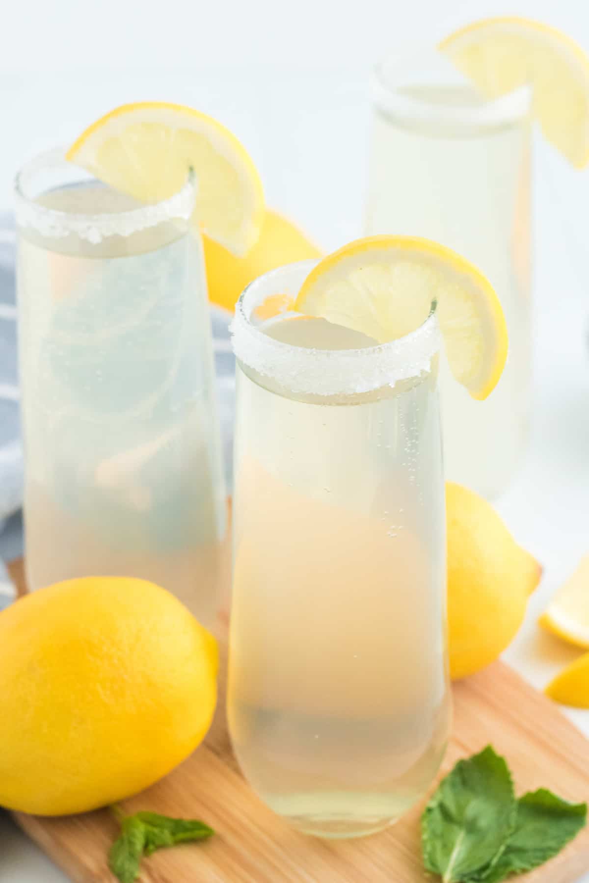 Lemonade mimosa with a sugar rim and a lemon slice.