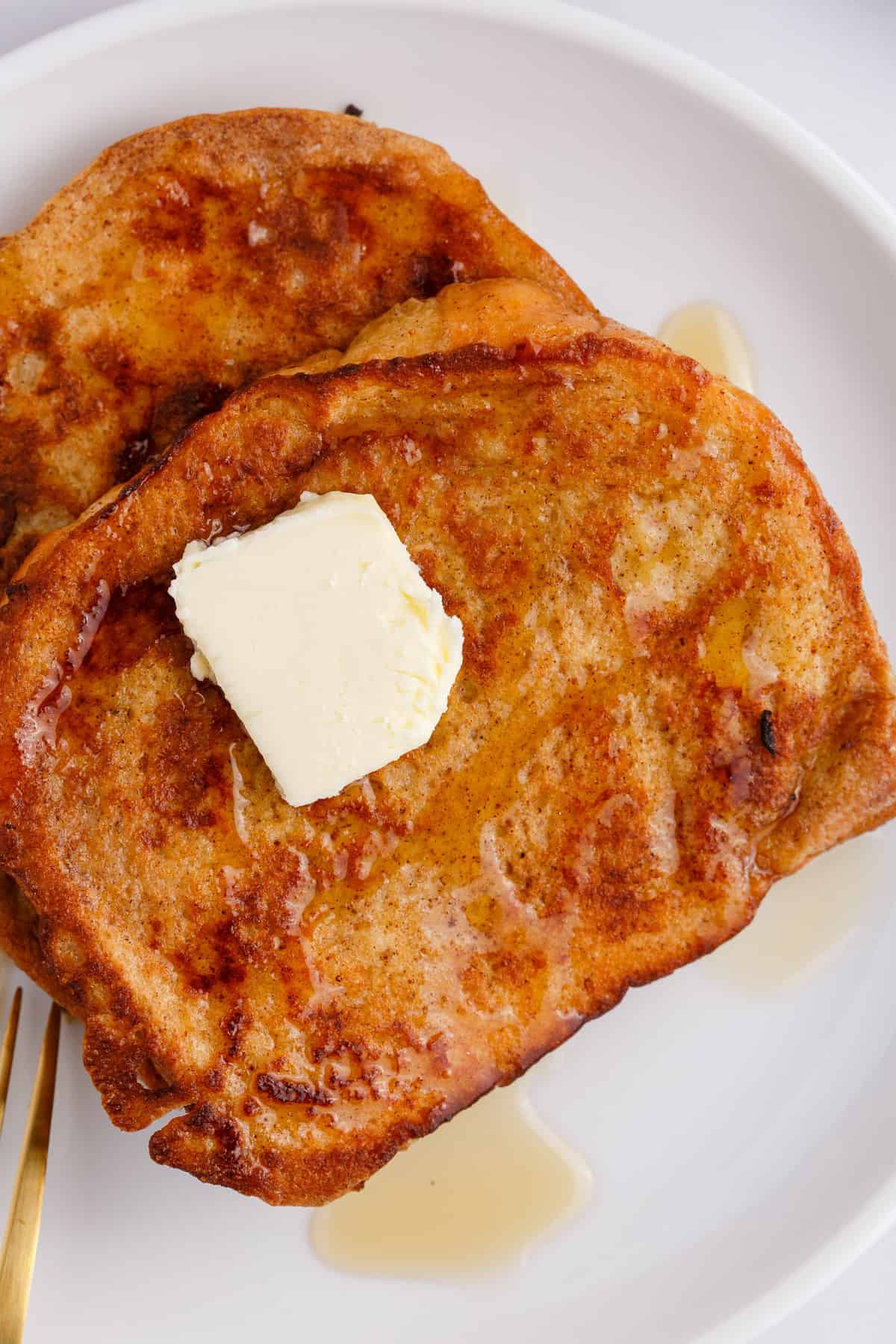 Classic french toast with butter and syrup.