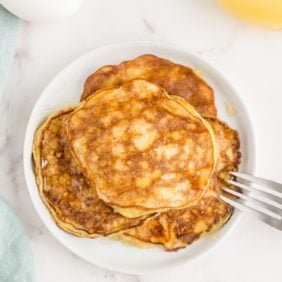 Stack of two ingredient banana pancakes on a white plate.