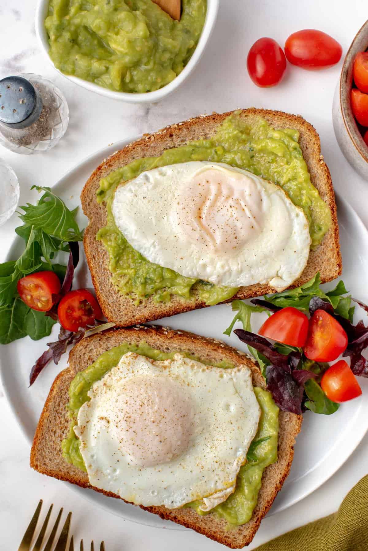 Two basted eggs on avocado toast.