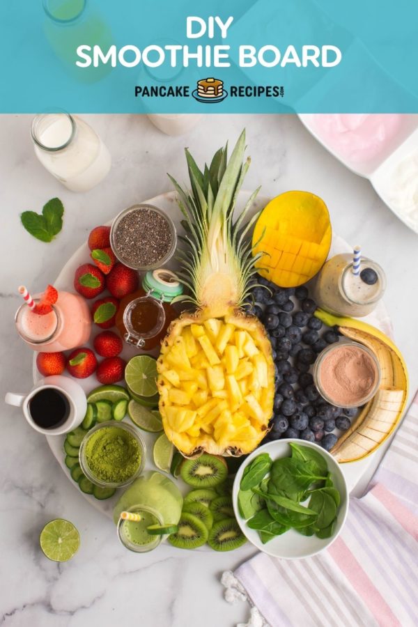 Fruit and yogurt arranged on a platter, text overlay reads "DIY smoothie bar, pancakerecipes.com."