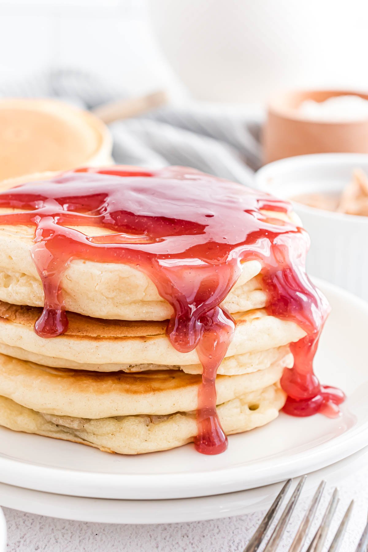 Stack of pancakes with jelly syrup.