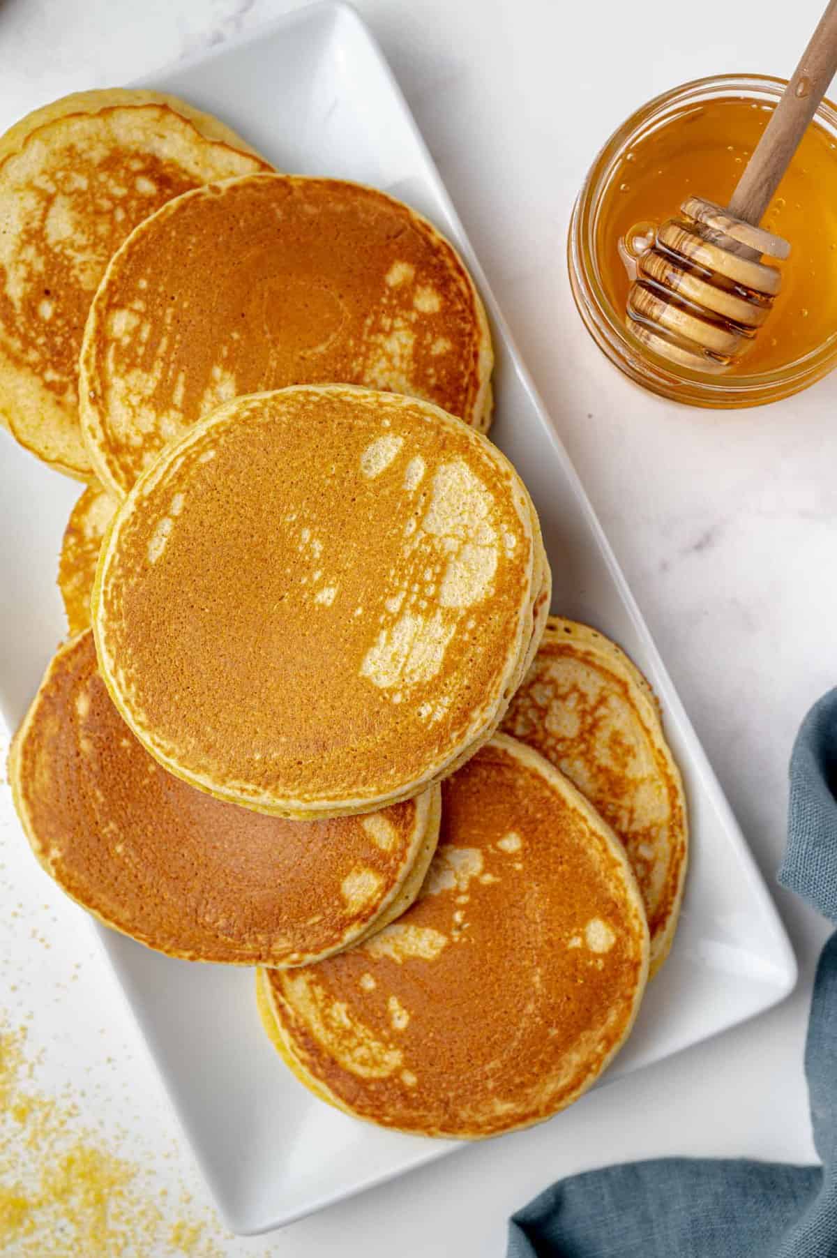 Pancakes on a white rectangular platter.