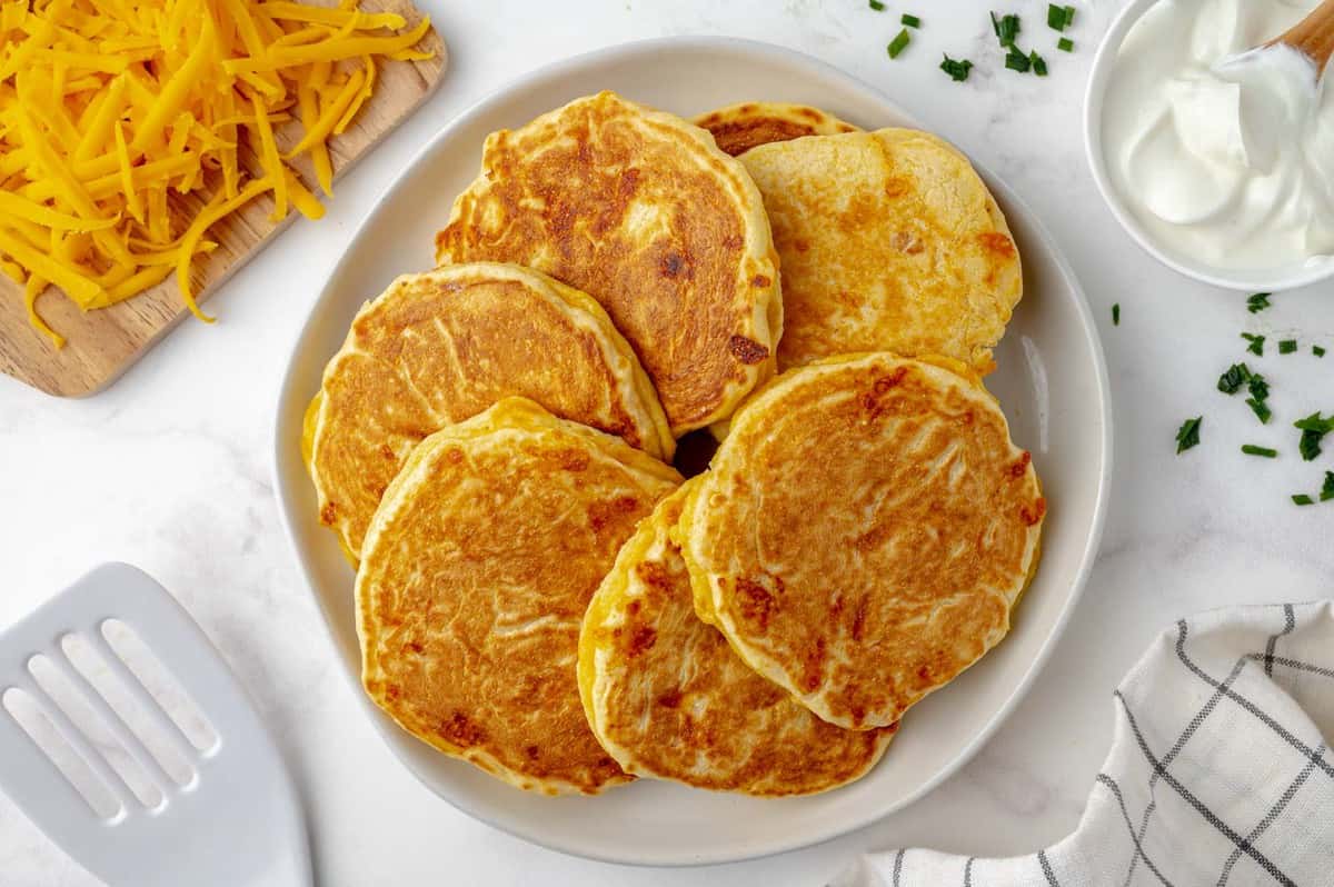 Cornmeal pancakes arranged on a platter.