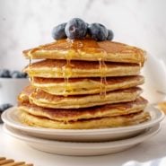 Stack of low carb pancakes with syrup and blueberries.