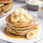 Stack of banoffee pie pancakes with caramel sauce and bananas.