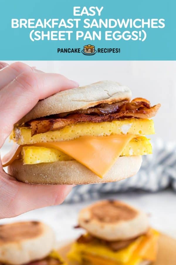 Hand holding sandwich, text overlay reads "easy breakfast sandwiches - sheet pan eggs!"