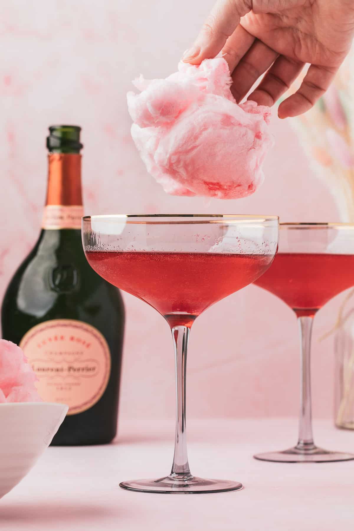 Cotton candy added to glass of champagne.
