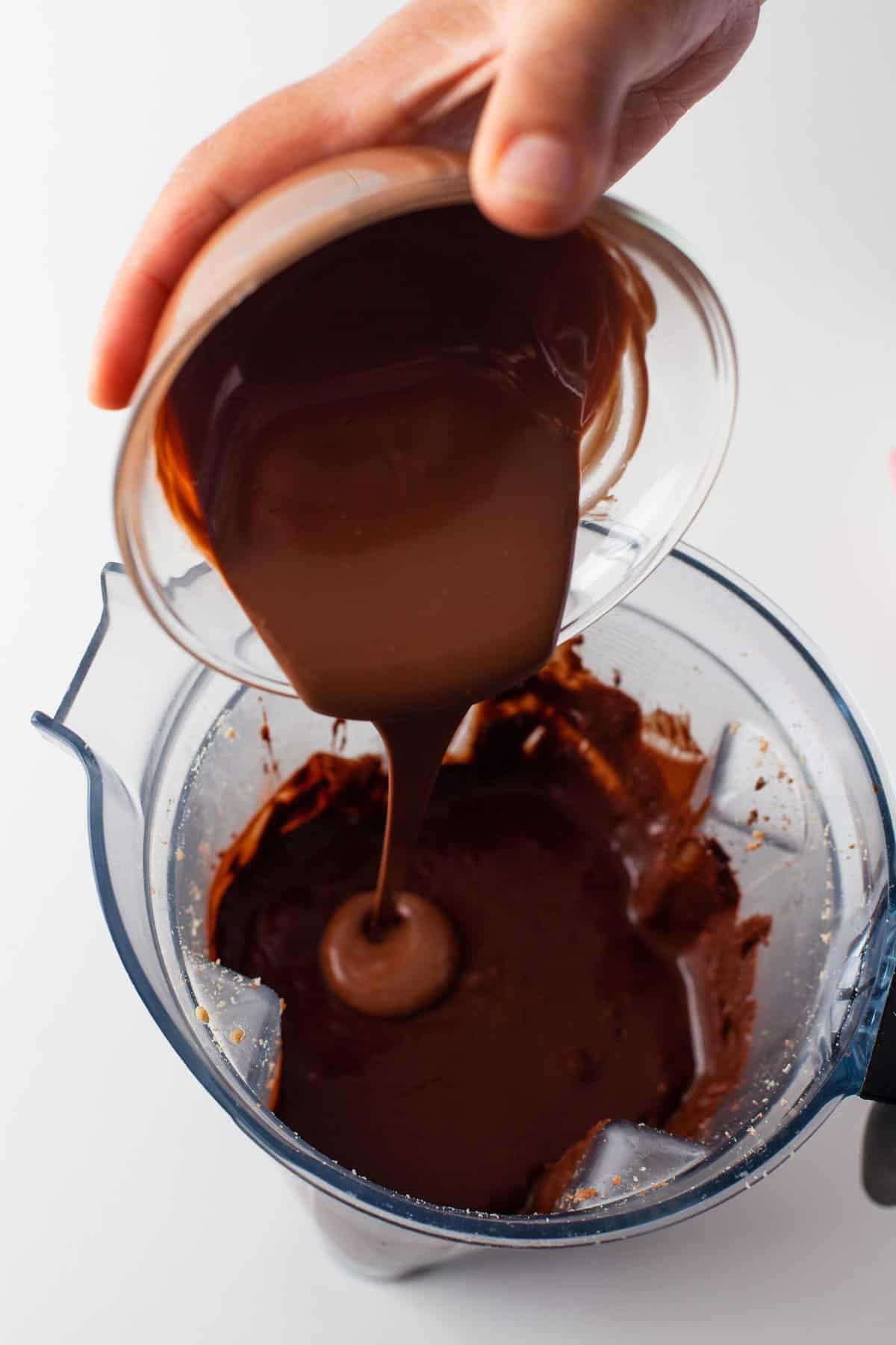 Melted chocolate being poured into a blender.