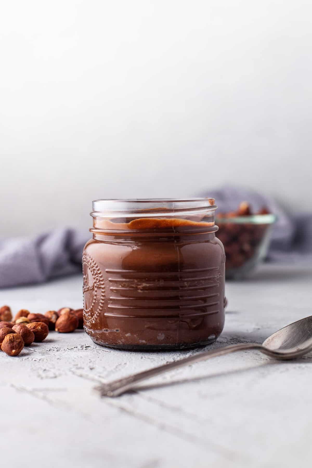 Homemade Nutella in a small glass jar.