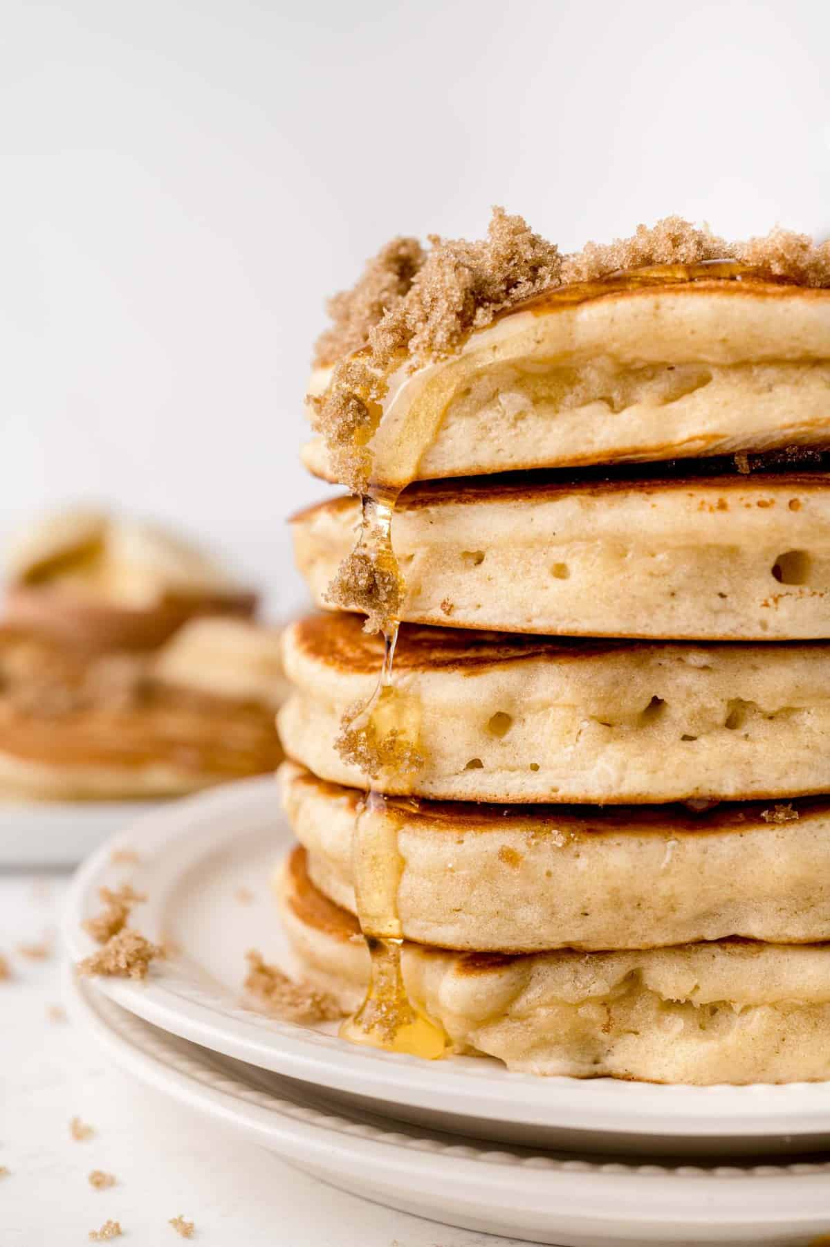 Stack of fluffy brown sugar pancakes topped with brown sugar.
