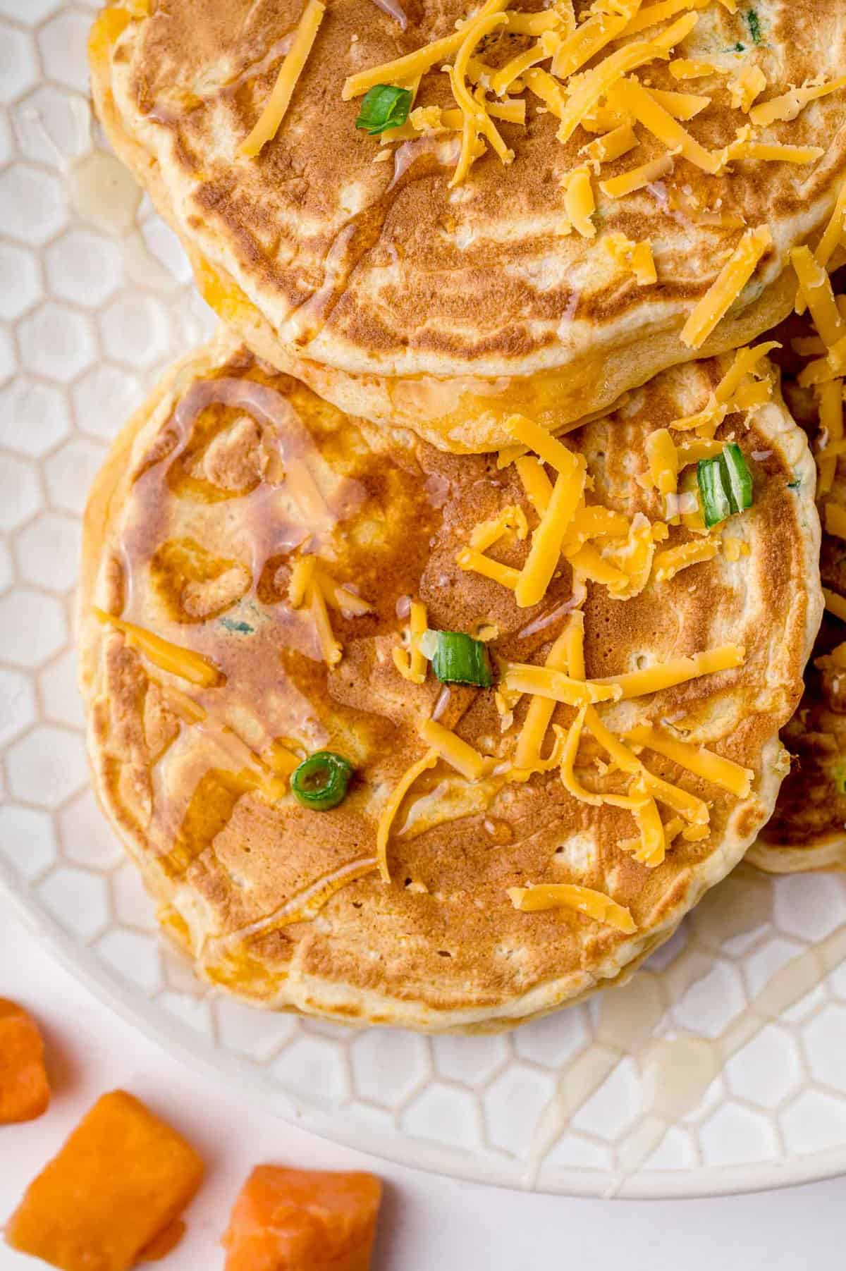 Pancakes topped with cheese.