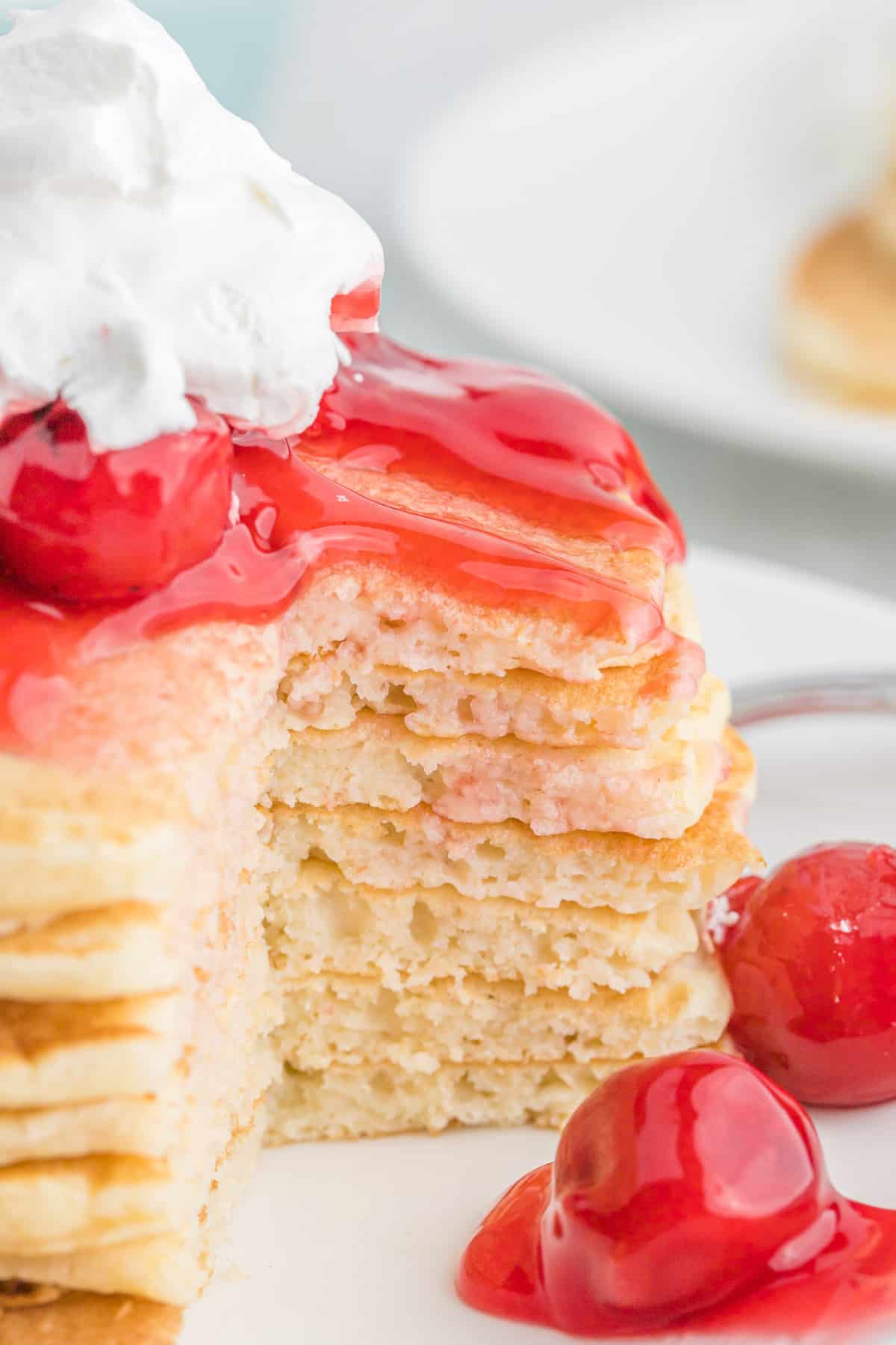 Stack of cherry pie pancakes, cut to show texture.