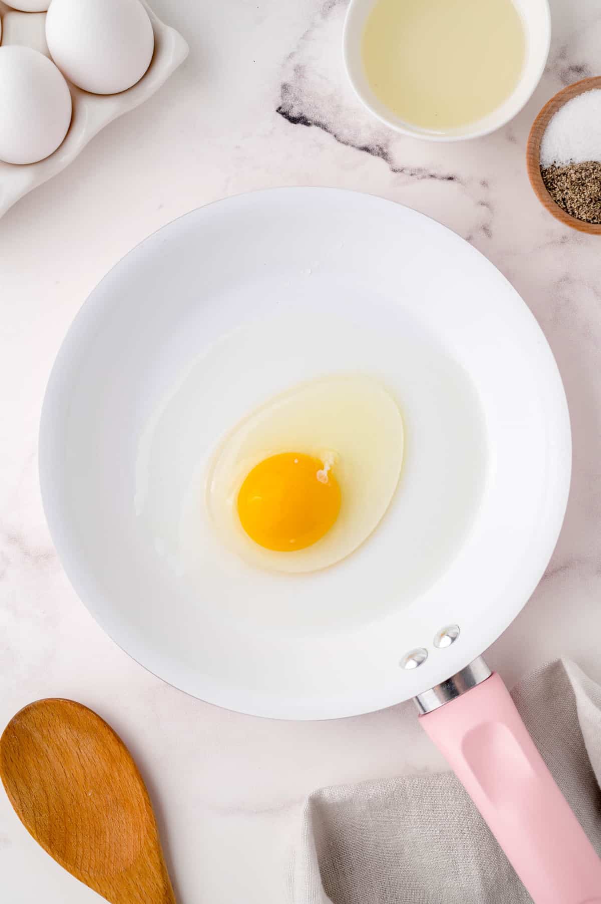 Uncooked egg in a frying pan.