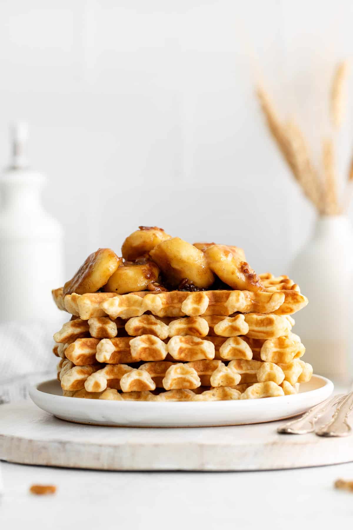 Banana topping on a stack of waffles.