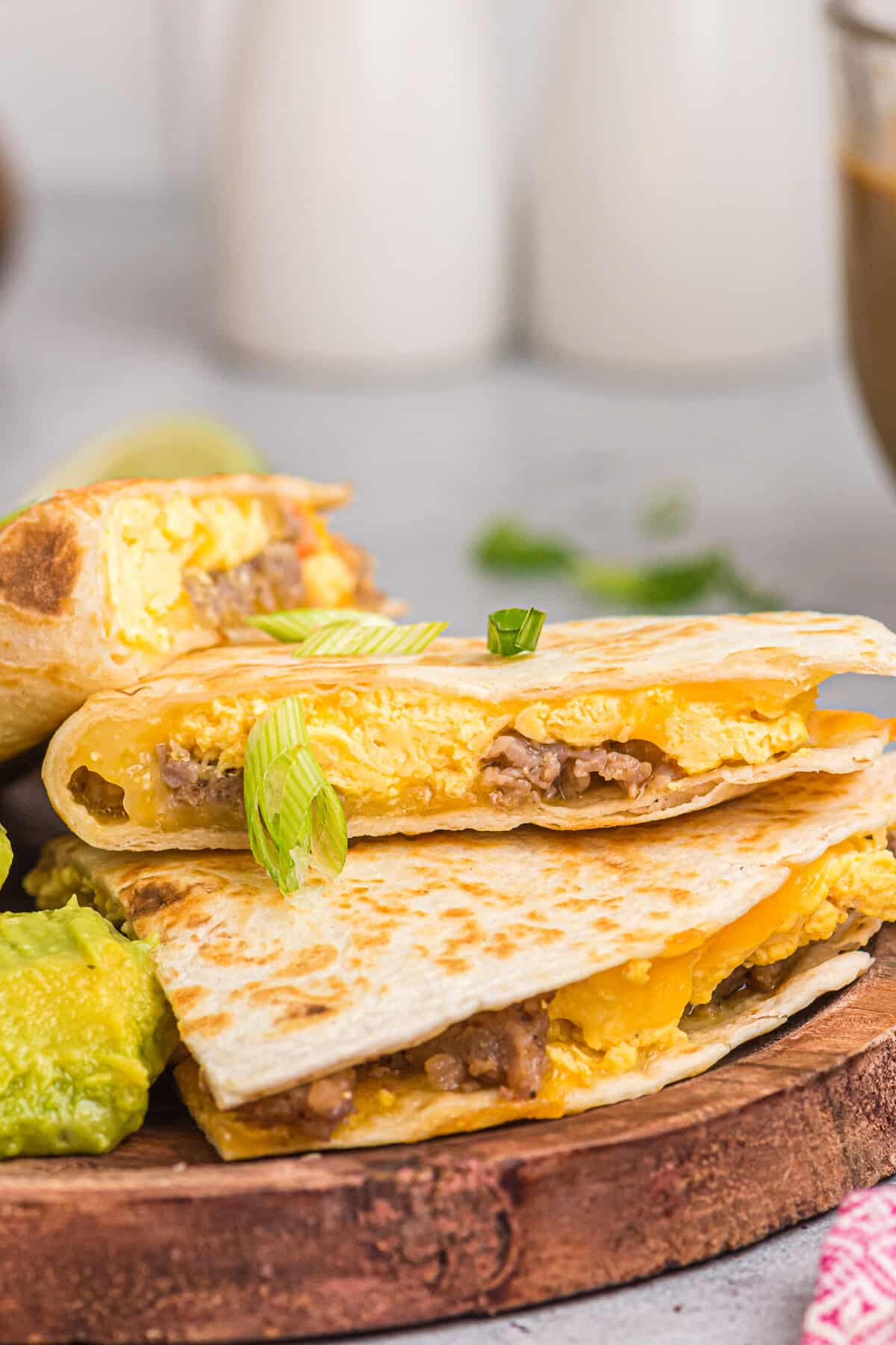 Breakfast quesadillas on a wood platter.