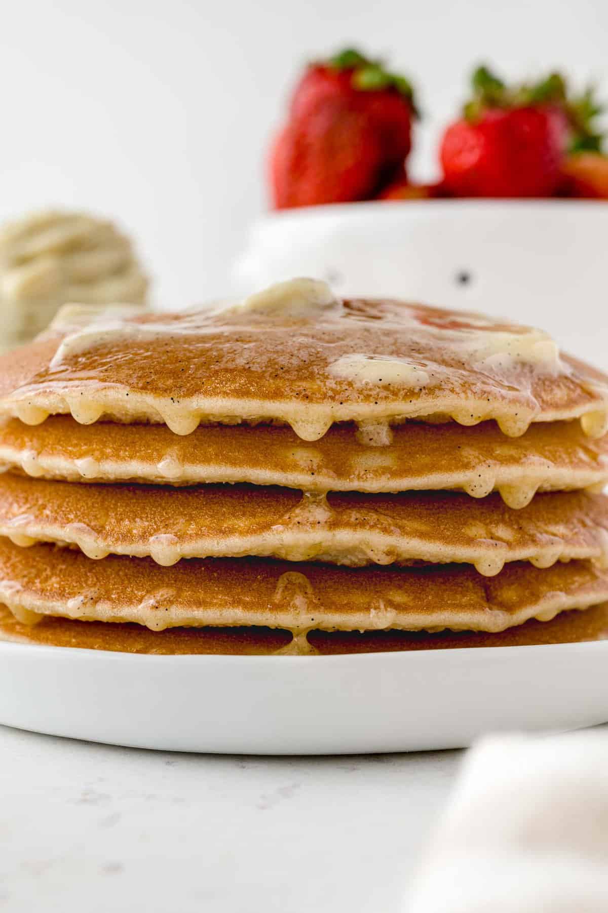 Butter dripping down stack of pancakes.