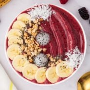 Berry smoothie bowl with assorted toppings.