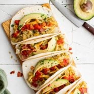 Breakfast tacos topped with avocado.