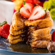 Stack of nutella stuffed french toast cut open to show filling.