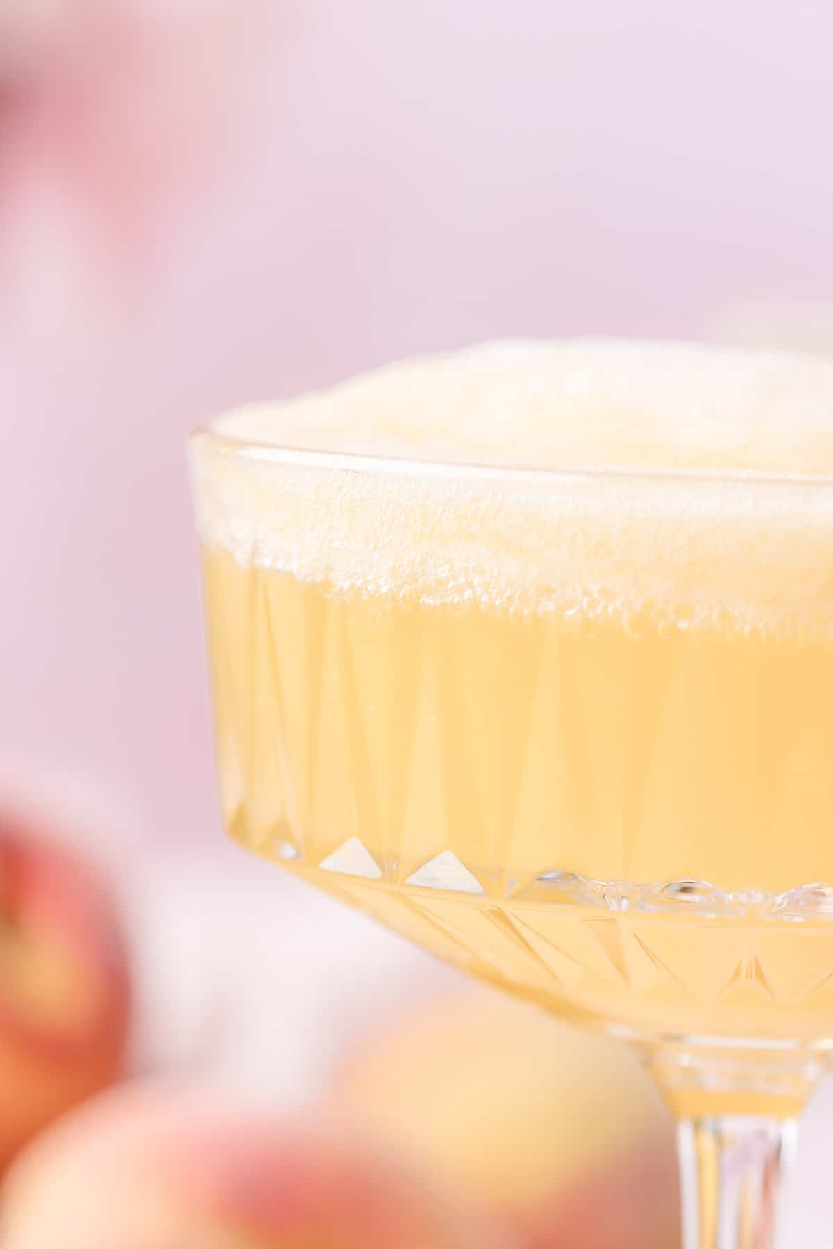 Close up of a bubbly peach bellini.