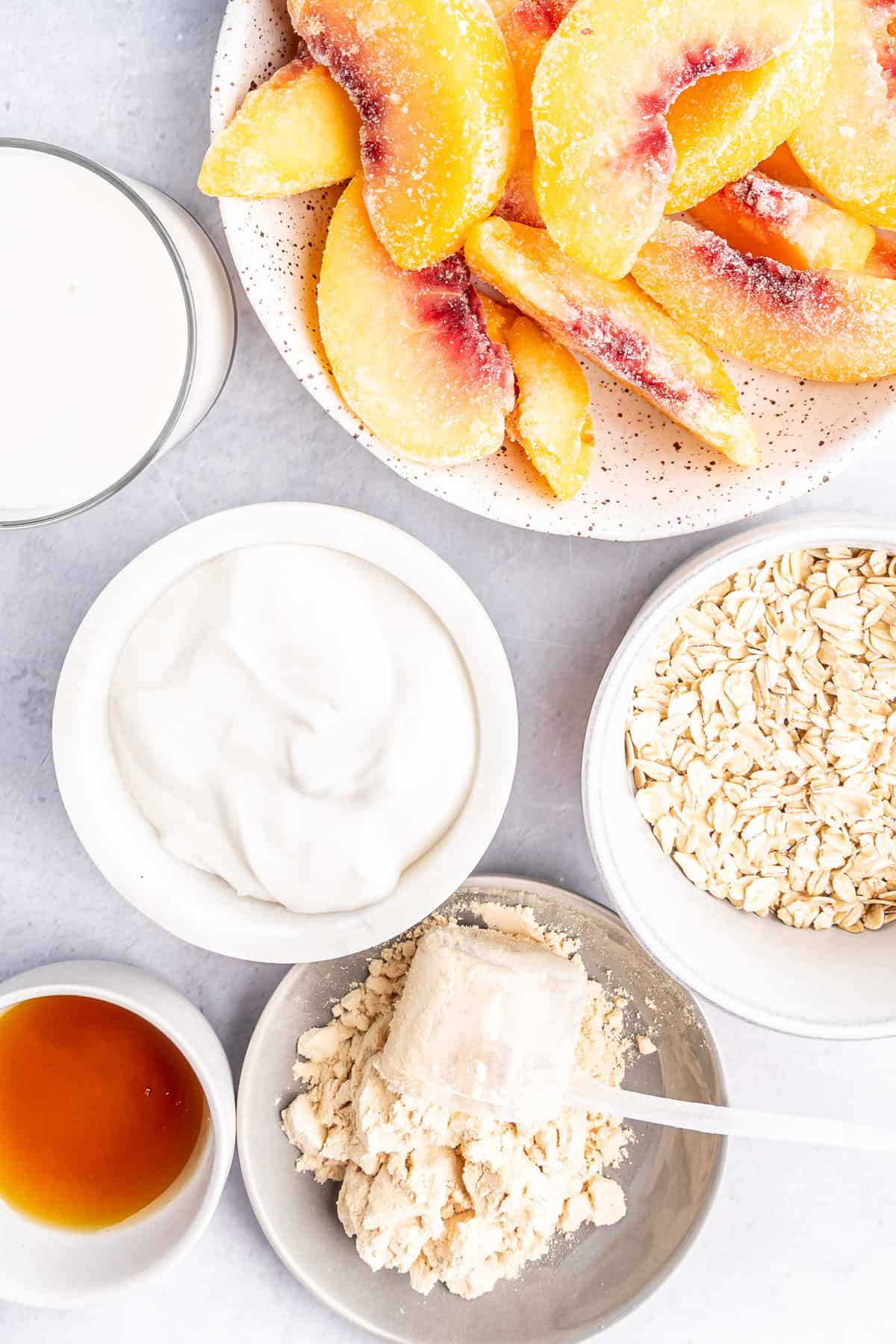 Ingredients needed for recipe including frozen peaches and oats.