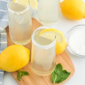 Lemonade mimosas on a wooden tray.