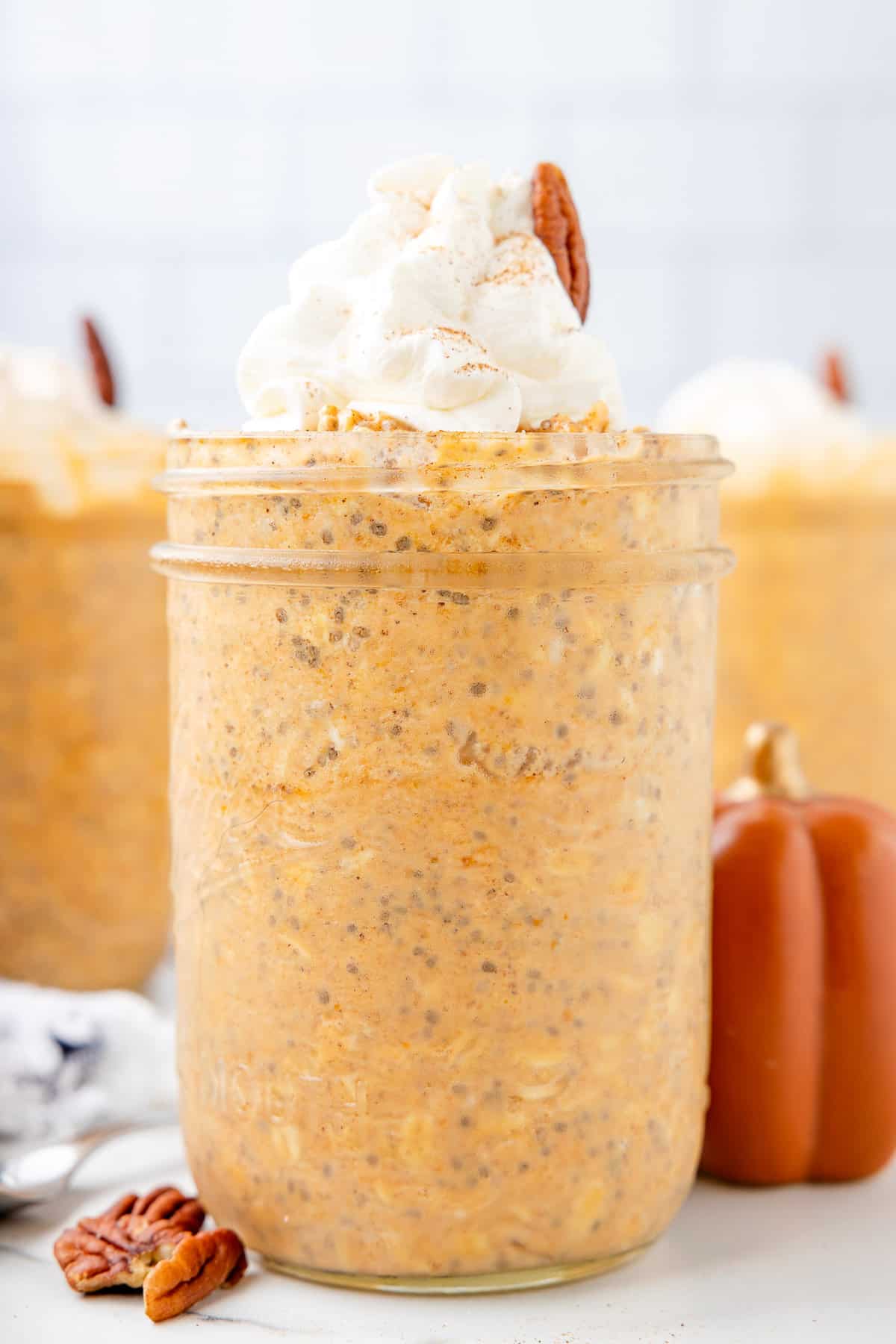 Pumpkin overnight oats in a jar with whipped cream.