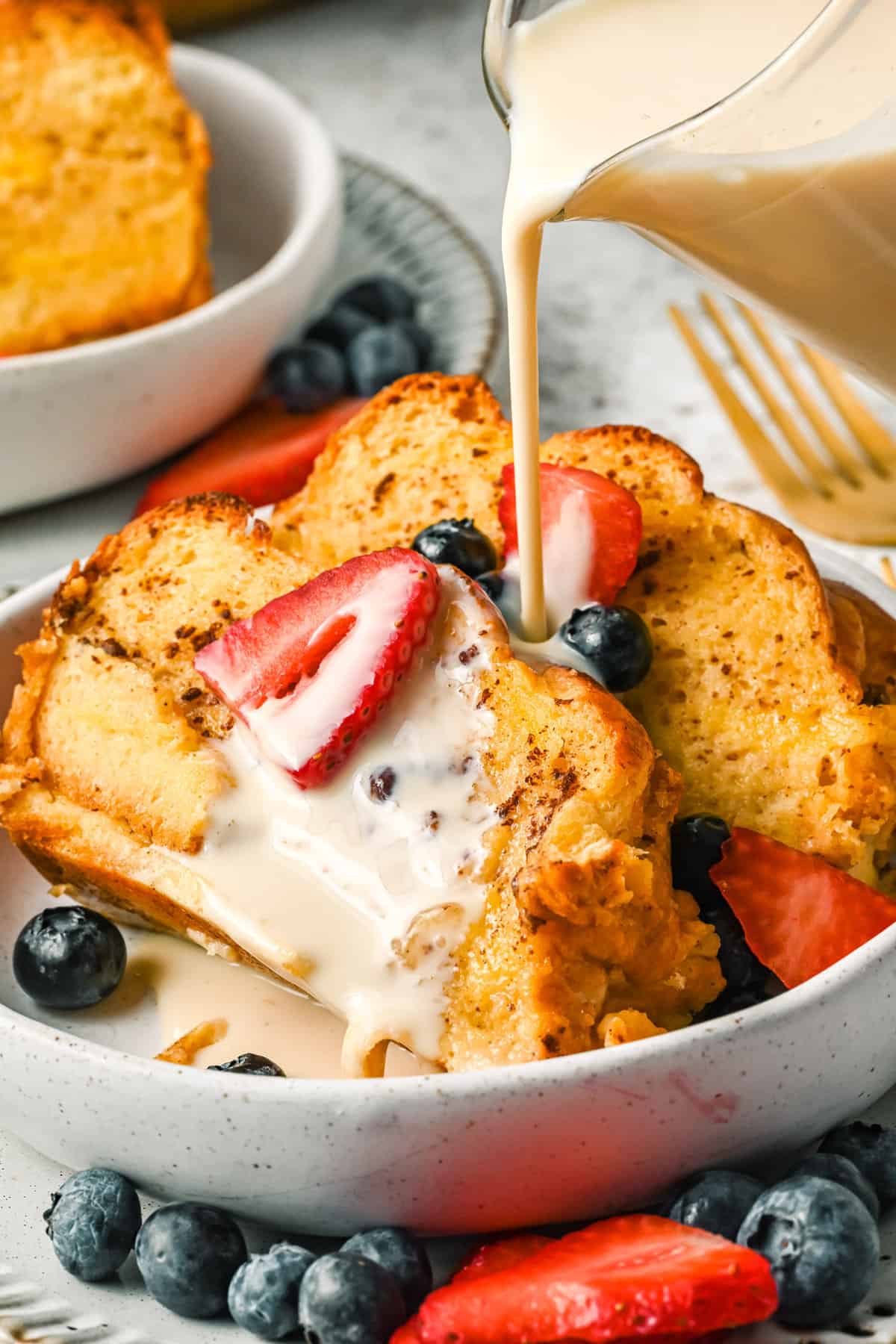 Tres leches french toast casserole garnished with berries.