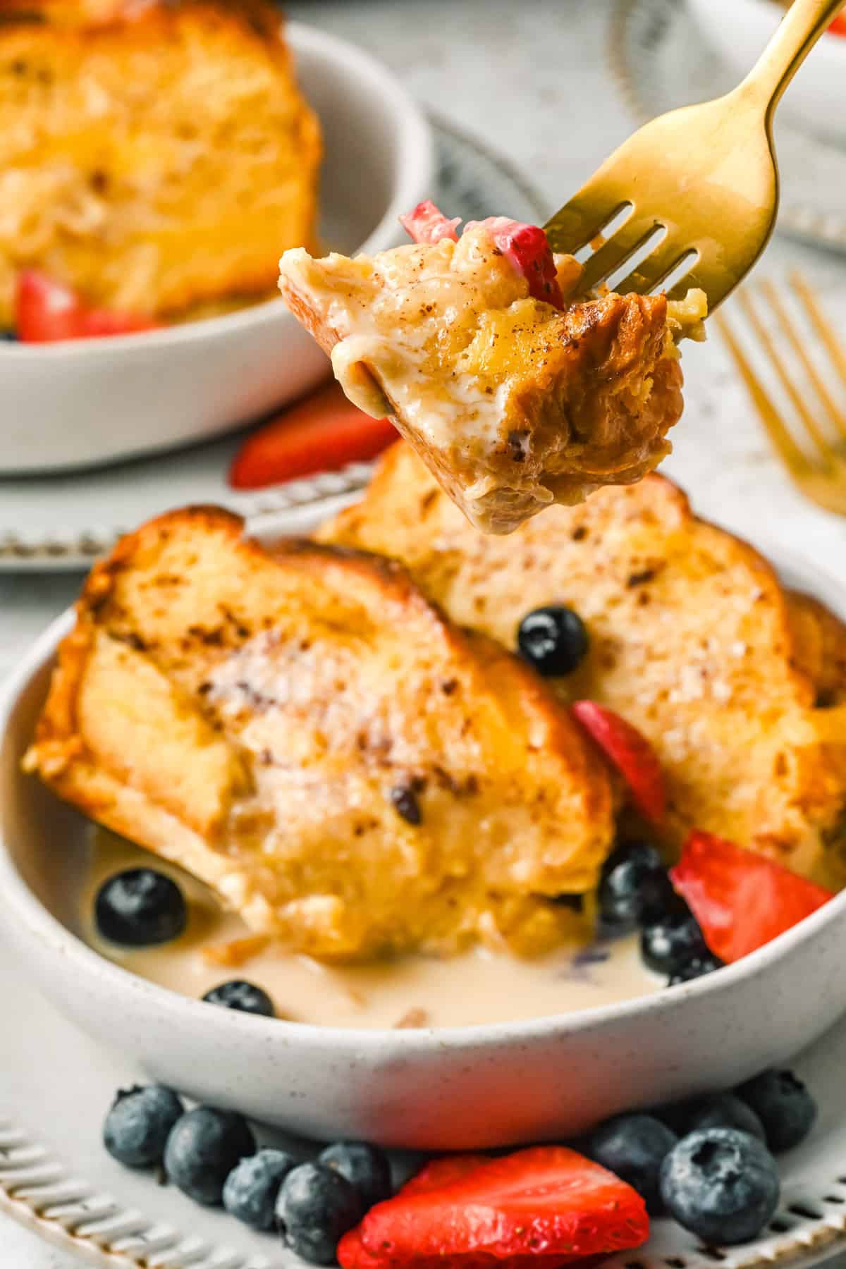 Fork with french toast casserole on it.