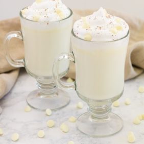 White hot chocolate in two clear glass mugs.
