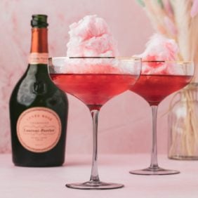 Two champagne cocktails with cotton candy.