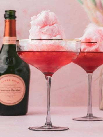 Two champagne cocktails with cotton candy.