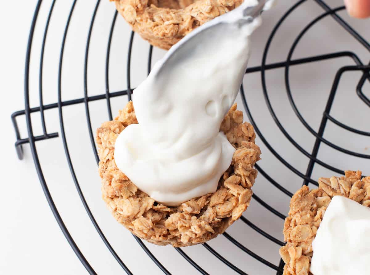 Yogurt being added to oat cup.