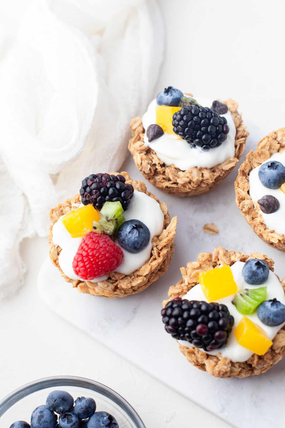 Oatmeal cups filled with yogurt and fresh fruit.