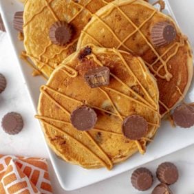 Peanut butter cup pancakes topped with peanut butter.